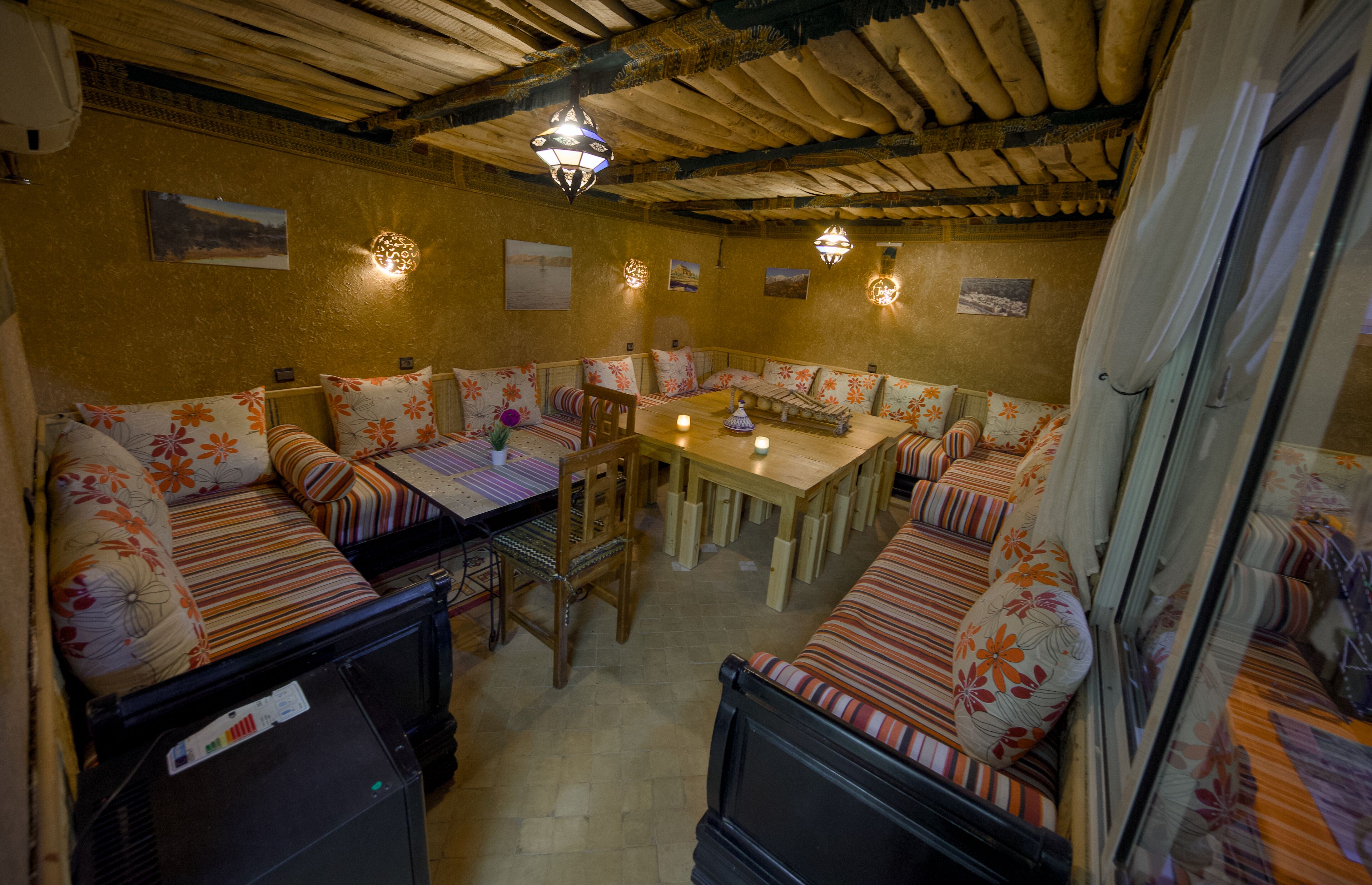 A cozy, rustic dining area with wooden furniture and floral upholstery.