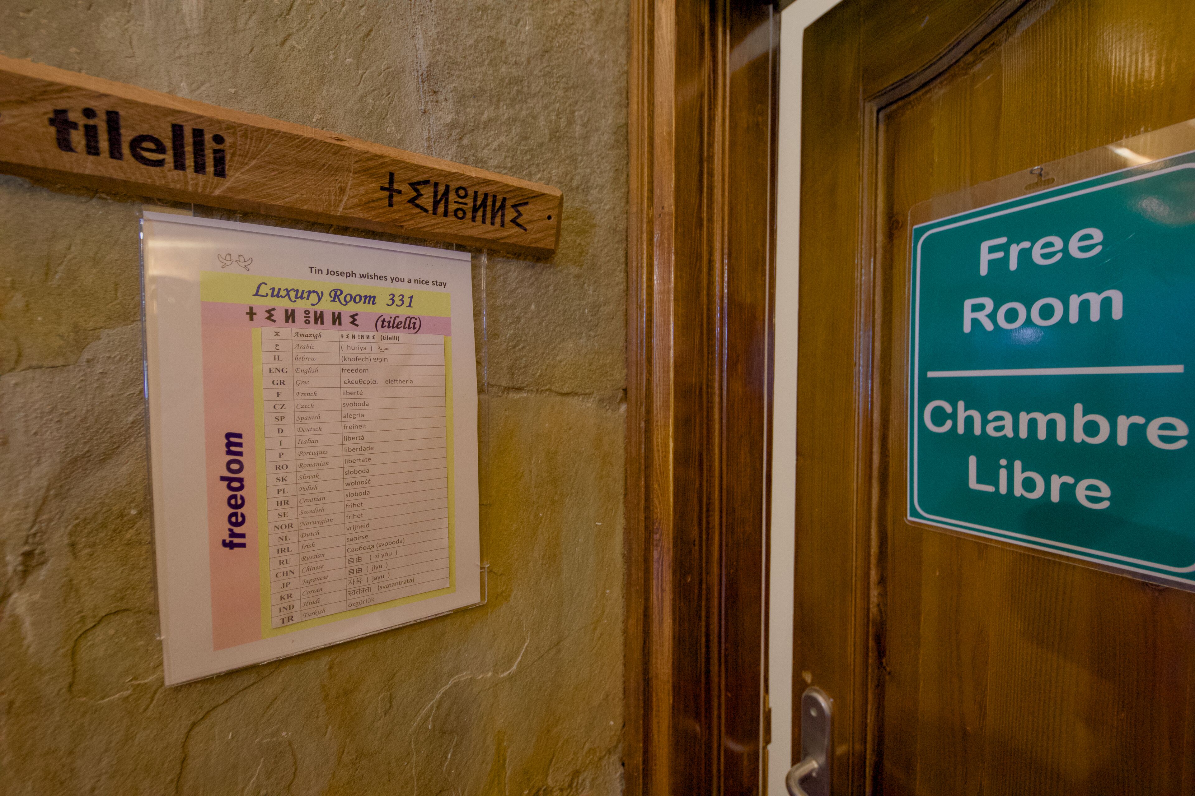 A sign for a free room and a multilingual menu board.