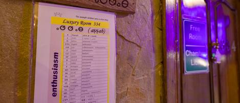 A sign for Luxury Room 334 with a list of languages and the word "enthusiasm" highlighted.