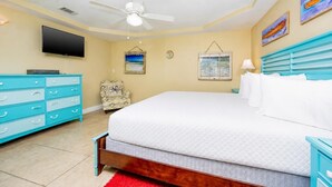 A bedroom with a bed, a TV, a ceiling fan, a chair, and artwork on the walls. - PENTHOUSE 3 BR! One Of A Kind! L@@K @ This BEACH VIEW!! (Gulf Shores)