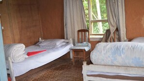 A room with two beds, a chair, and a window with curtains. - Nagarkot Community Homestay (Mahamanjushree Nagarkot)