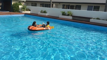 Seasonal outdoor pool, open 7:00 AM to 9:00 PM, pool umbrellas
