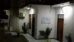 A building with a sign reading "A to Zee" and a door. There are potted plants and a small outdoor area with a white floor. - Atozee Airport villa (Seeduwa - Katunayake)