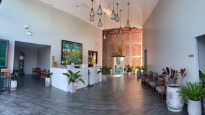 A spacious lobby with a reception desk, seating area, and decorative plants. - Atom Phuket Hotel (Sa Khu)