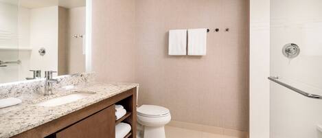 A bathroom with a sink, toilet, and shower.