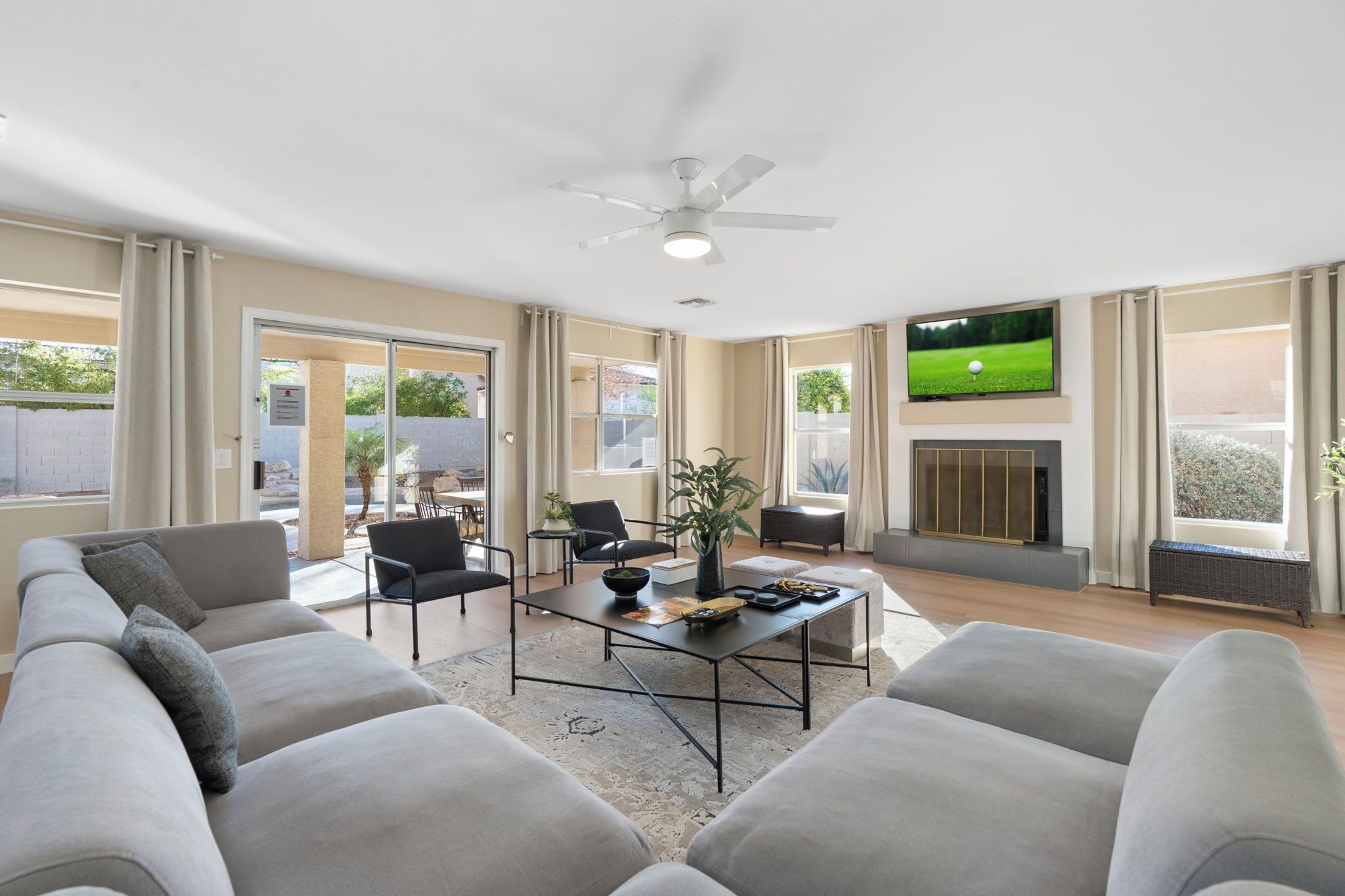 A spacious living room with a sofa, coffee table, and TV.
