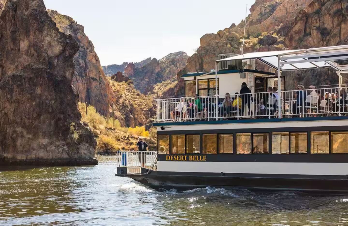A boat named 'Desert Belle' with a covered upper deck and a lower deck.