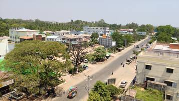 A street view with buildings, trees, and a clear sky.