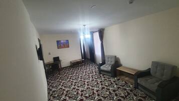 Deluxe Double Room | Living area | Flat-screen TV