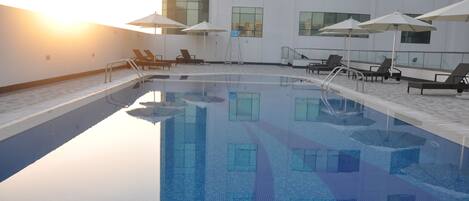 Outdoor pool, open 8:00 AM to 8:00 PM, pool umbrellas, sun loungers
