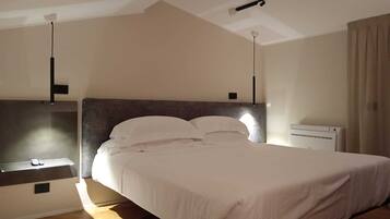 A bedroom with a bed, bedside table, and an air conditioning unit.