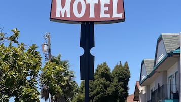 A motel sign with a classic design, including a large signboard and a directional arrow.