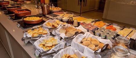 Um buffet com diversos alimentos e acompanhamentos.