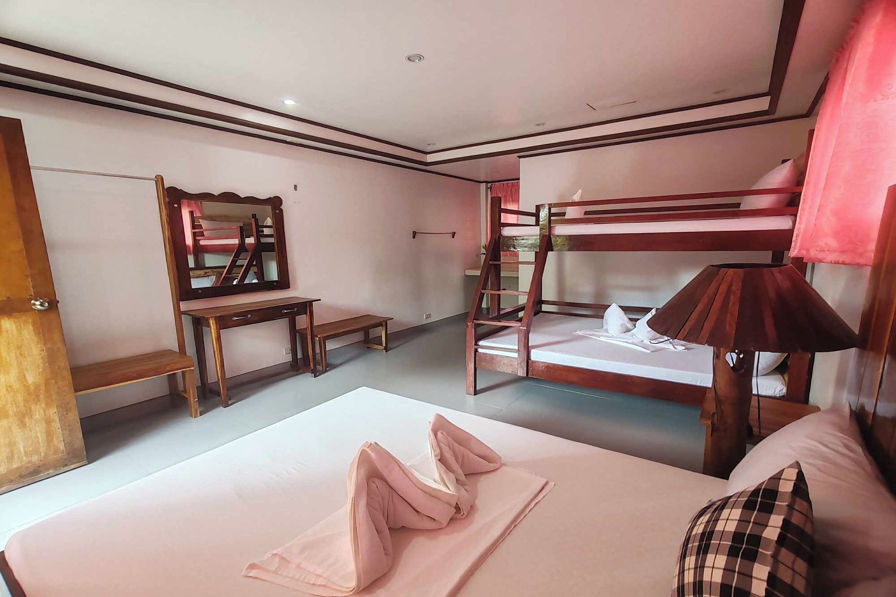 Family Room | Desk, iron/ironing board, bed sheets