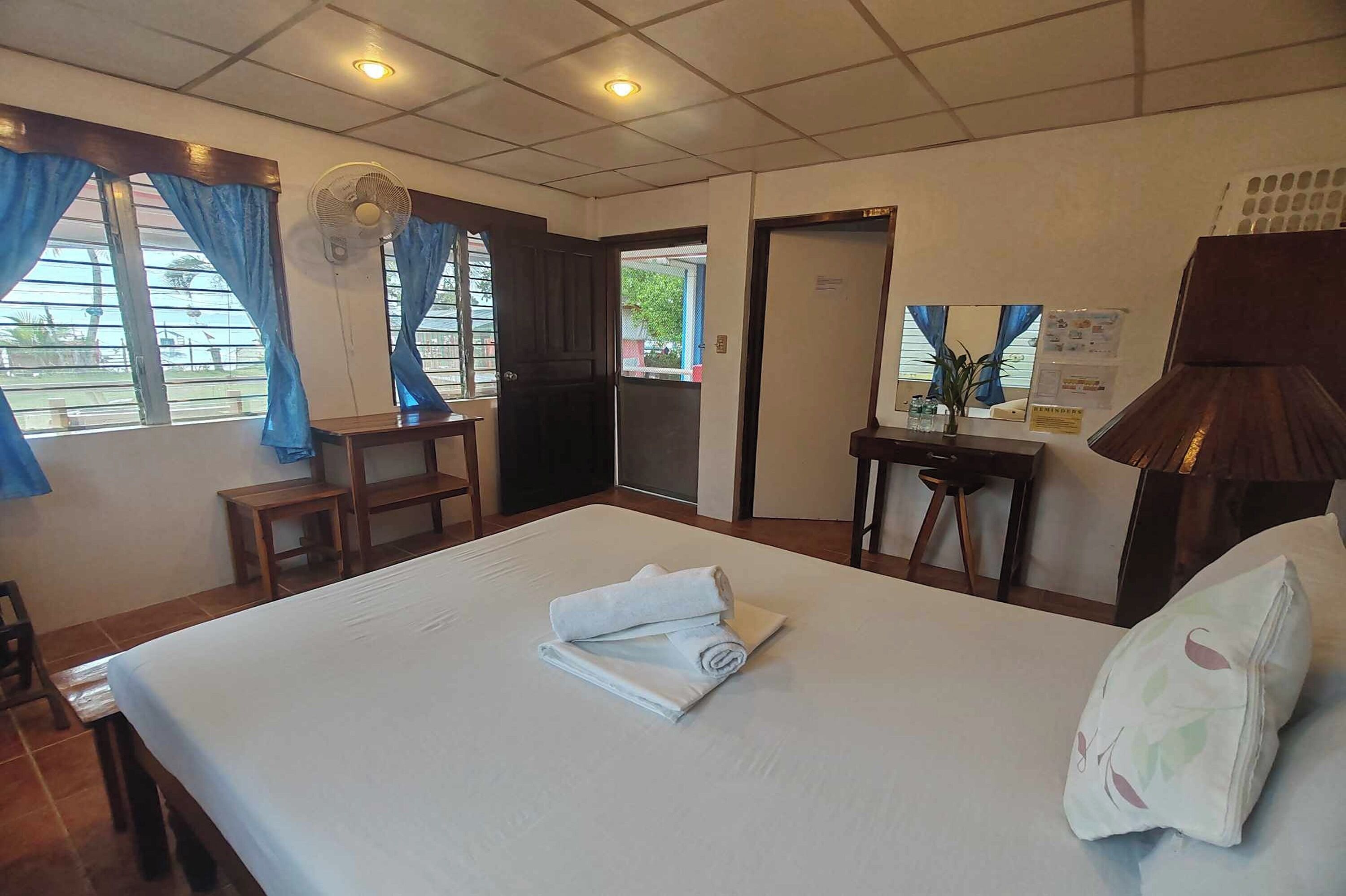 Desk, iron/ironing board, bed sheets
