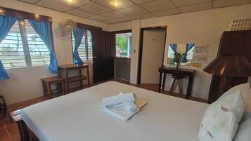 Desk, iron/ironing board, bed sheets
