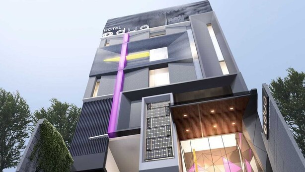 A modern hotel with a unique architectural design, featuring a prominent vertical stripe and a mix of glass and metal materials. - Odua Thamrin Jakarta (Jakarta)