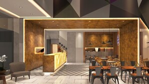 A modern interior with a central kitchen area, dining space, and seating arrangement. - Odua Thamrin Jakarta (Jakarta)