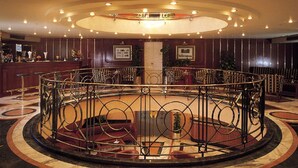 A circular lobby with a central fountain, a reception desk, and seating areas. - Jaz Celebrity Nile Cruise - Every Saturday from Luxor for 07 and 04 Nights - Every Wednesday From Aswan for 03 Nights (Luxor)