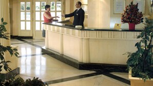 A hotel reception area with a marble floor, a reception desk, and a large window with a view of greenery outside. - Jaz Crown Prince Nile Cruise - Every Monday from Luxor for 07 & 04 Nights - Every Friday From Aswan for 03 Nights (Luxor)