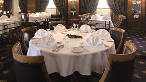 A formal dining room with round tables set for service, each with white tablecloths, silverware, and glassware. - Jaz Crown Prince Nile Cruise - Every Monday from Luxor for 07 & 04 Nights - Every Friday From Aswan for 03 Nights (Luxor)