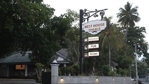 A sign for a rest house named Tangalle, indicating the presence of a restaurant, pub, and rooms. - Rest House Tangalle (Tangalle)