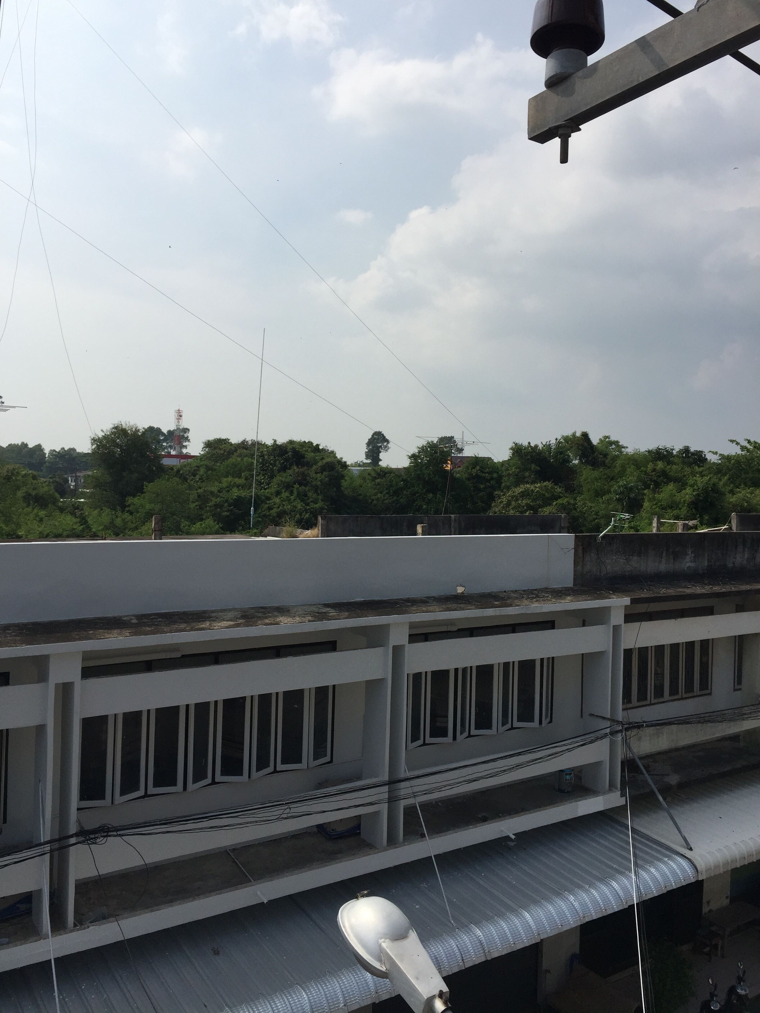 A building with multiple floors, large windows, and a flat roof.