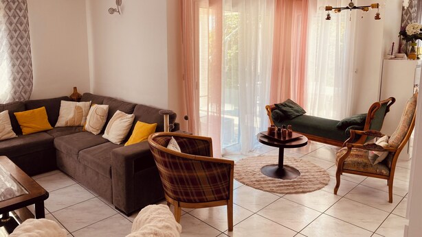 A living room with a sectional sofa, two armchairs, a coffee table, and a cat tree. - House close to the beach (Carnac)