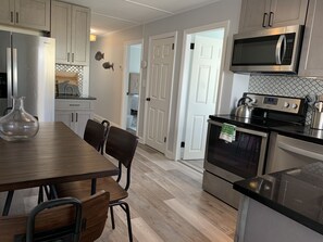 Microwave, dishwasher, coffee/tea maker, cookware/dishes/utensils