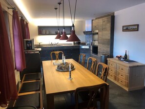 Enjoy cooking and dining in this well-equipped kitchen with a central island, oven, and coffee machine.