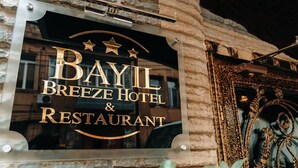 A sign for Bayil Breeze Hotel & Restaurant with a stone facade and ornate metalwork. - Bayil Breeze Hotel (Baku)