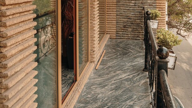 A modern building with a wooden exterior and a stone facade. - Bayil Breeze Hotel (Baku)