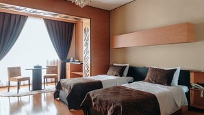 A modern hotel room with two beds, a desk, and a chair. - Bayil Breeze Hotel (Baku)