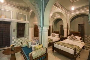 Classic design with a large bed, wooden bench, and decorative touches.