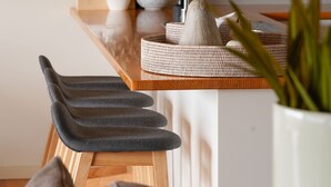 A modern kitchen with a wooden countertop, a sink, and a potted plant. - Salt Bush - Great views nestled  in the moonahs (St Andrews Beach)