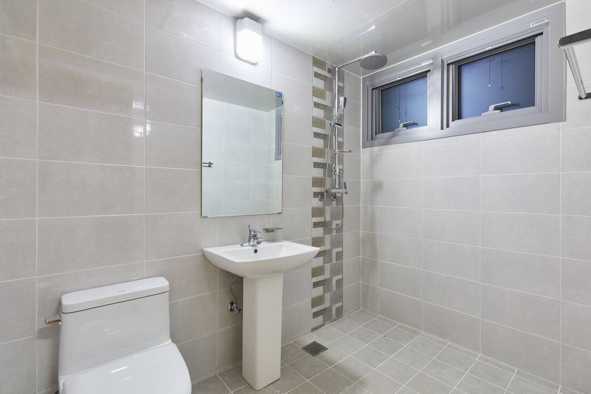 shower, hair dryer, towels, toilet paper