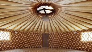 A spacious interior with a circular skylight, wooden lattice walls, and a central door. - Geumgangsong Ecorium (Uljin)