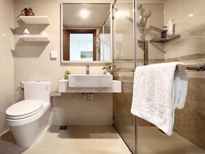 Studio | Bathroom | Rainfall showerhead, designer toiletries, hair dryer, slippers