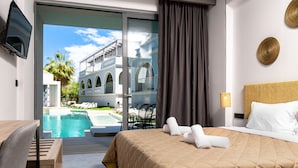 A hotel room with a bed, a TV, a pool view, and a balcony. - ArionGreen Riviera (Zakynthos)