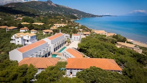 A coastal resort with multiple buildings, a swimming pool, and a view of the sea and mountains. - ArionGreen Riviera (Zakynthos)