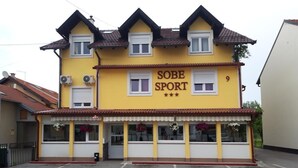 A yellow building with the sign "SOBE SPORT" and the number "9" on the facade.
