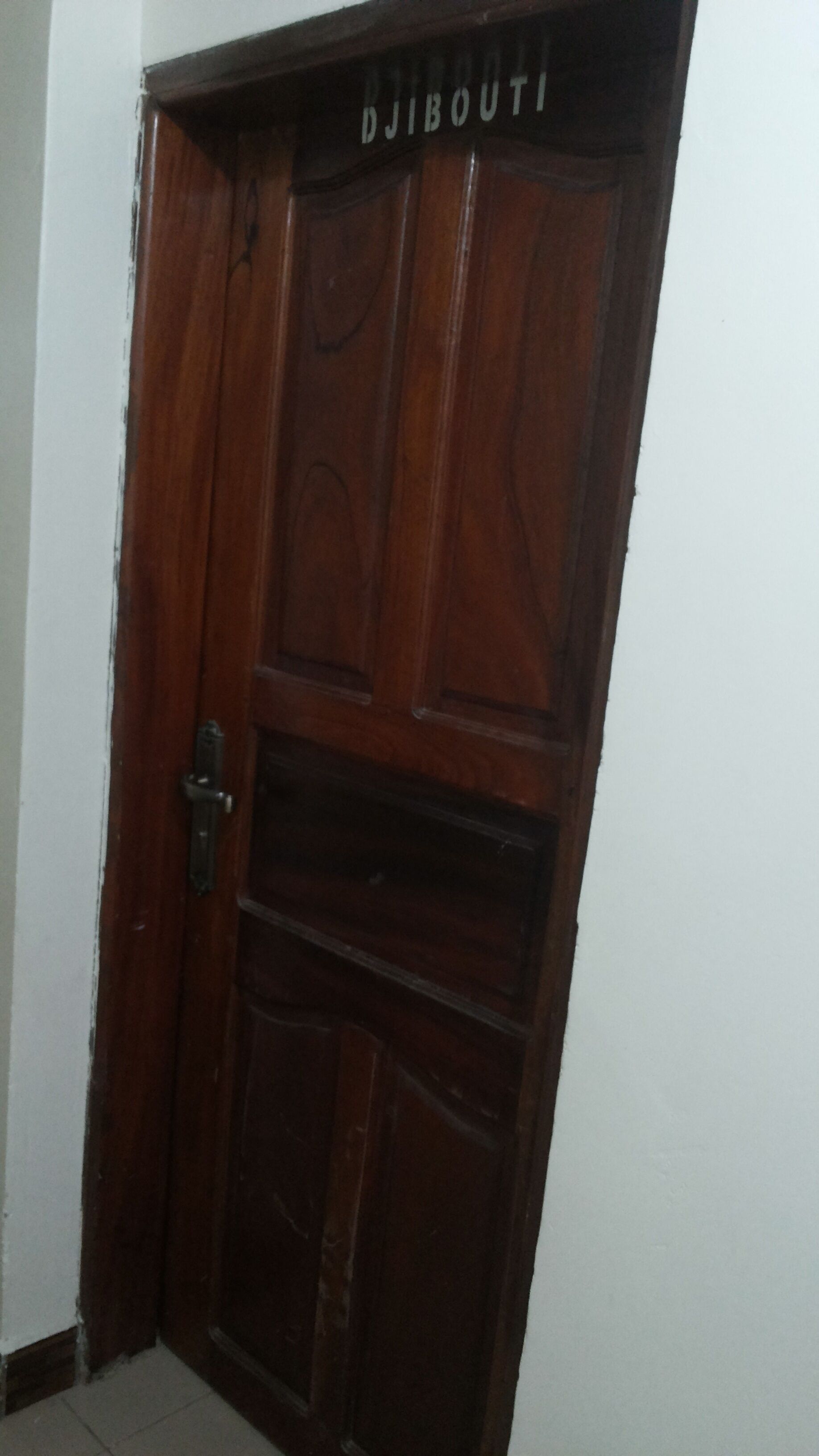 A wooden door with the name "DJIBOUTI" above it.
