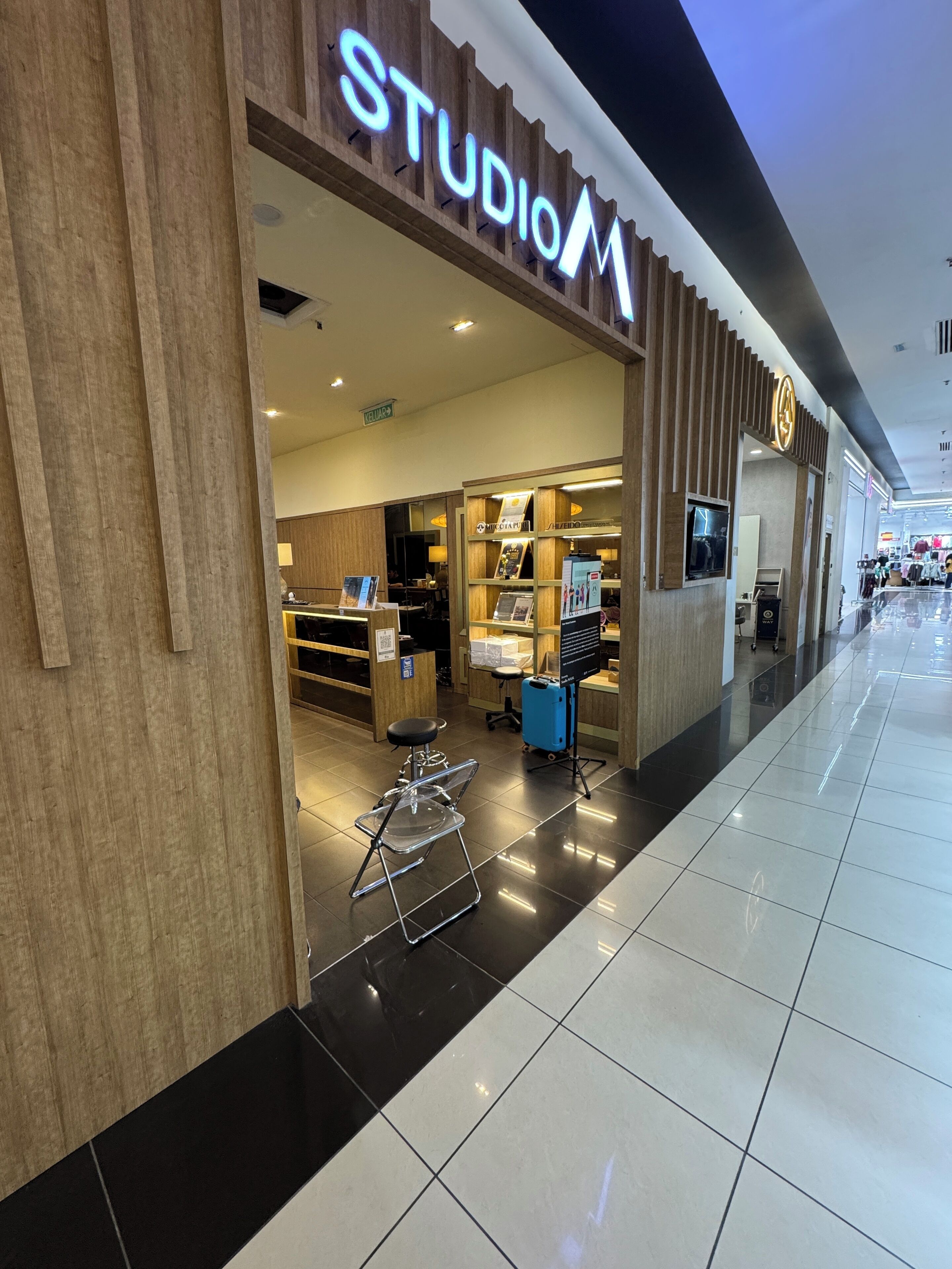 A store named STUDIO M with a wooden facade and a clear entrance.