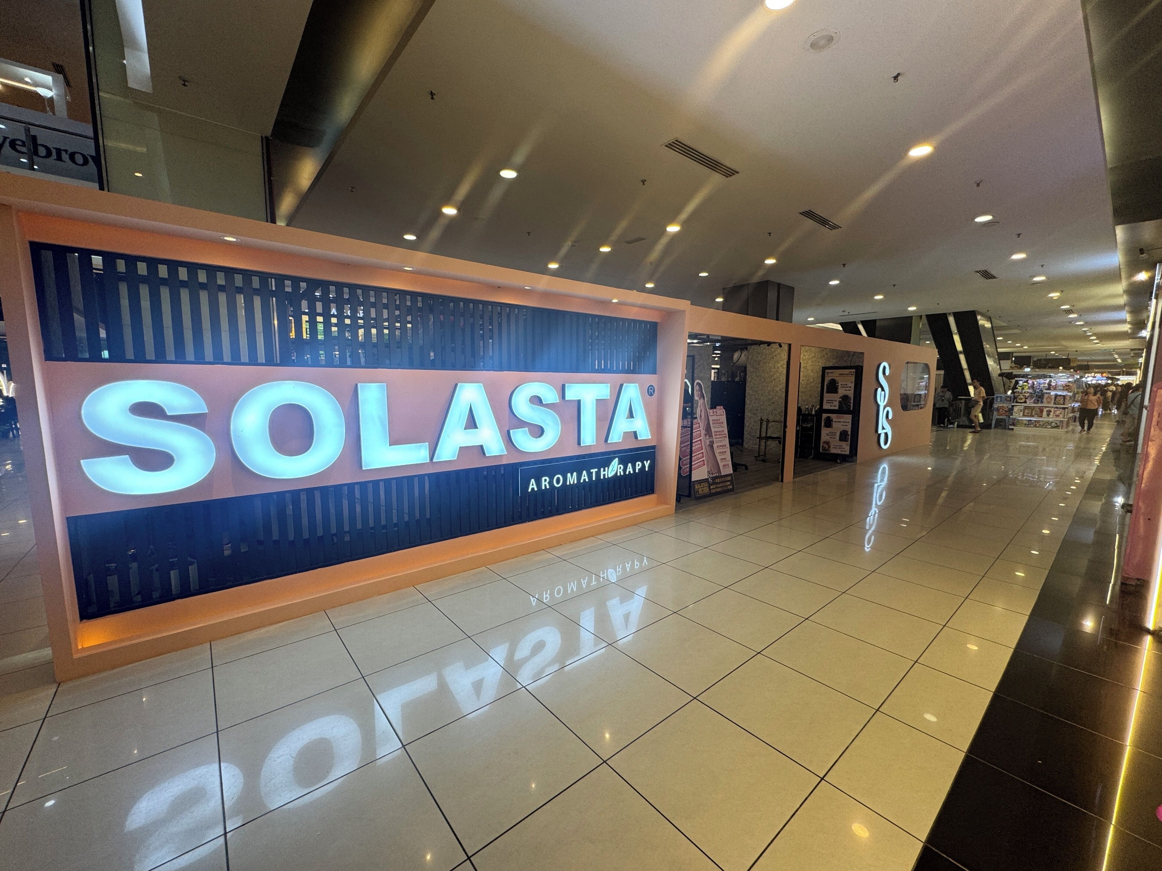 A Solasta aromatherapy store with a prominent sign in a shopping mall.