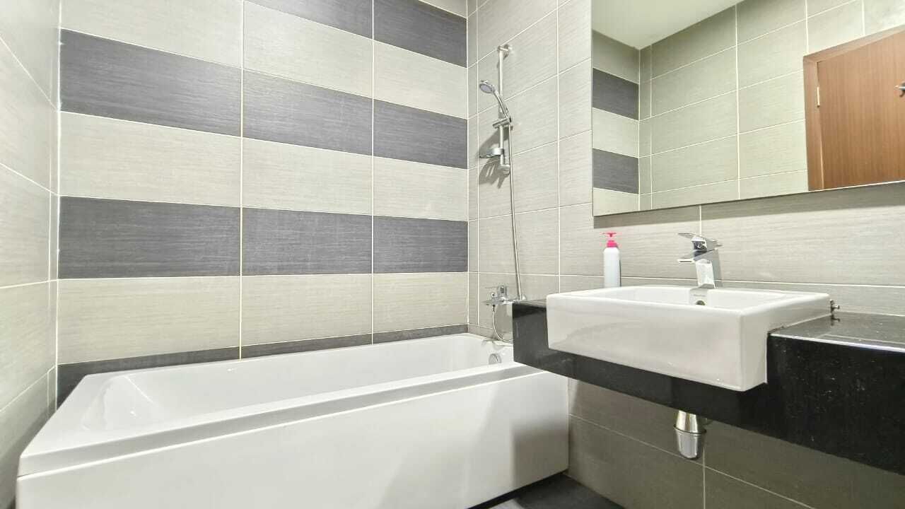A modern bathroom with a bathtub, a sink, and a shower.