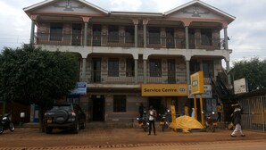 A multi-story building with a Service Centre on the ground floor. - Highway Motel (Nebbi)