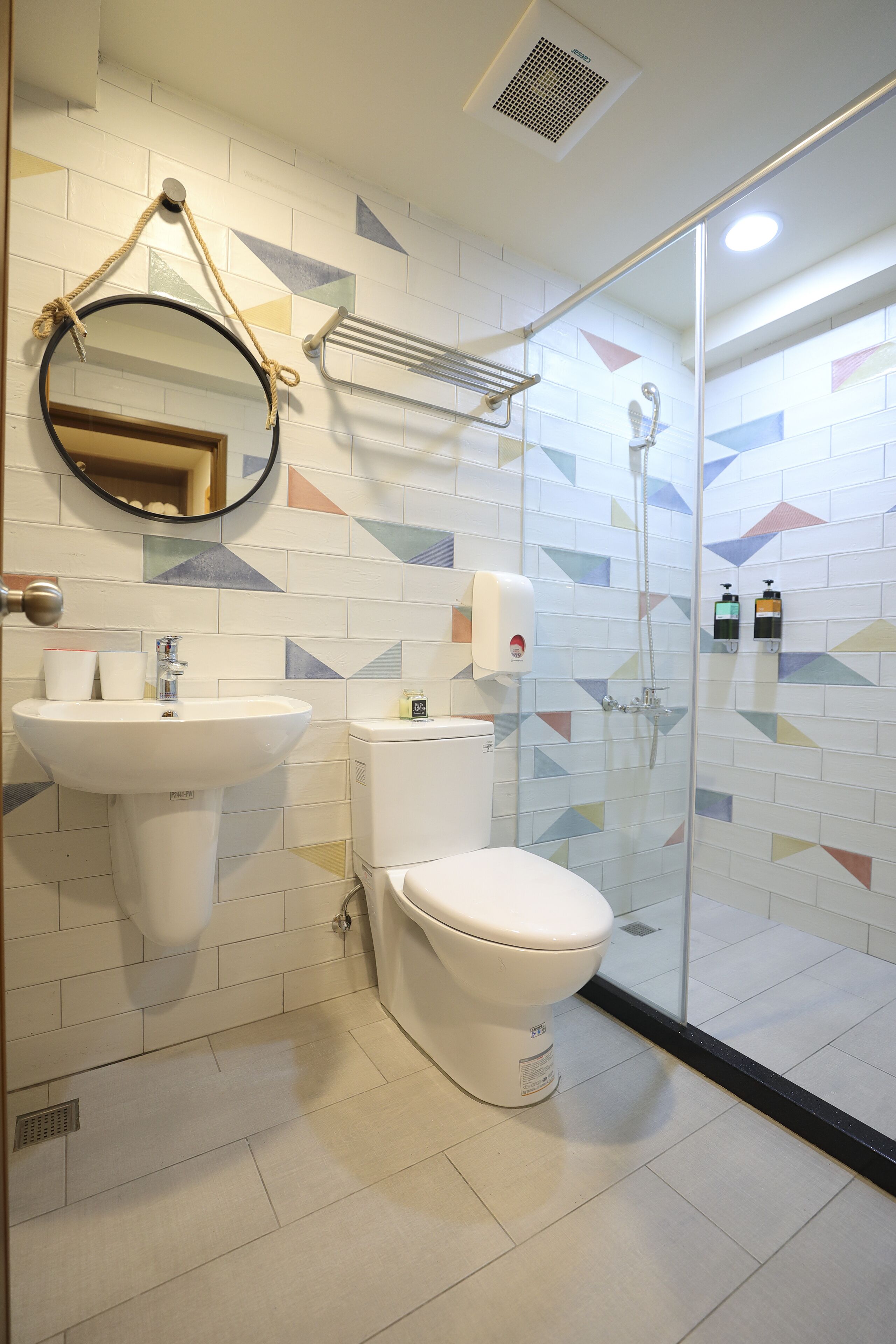 A bathroom with a sink, toilet, and shower.