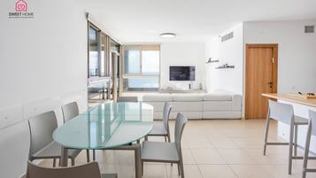 Luxury Apartment | Living area | 65-inch LCD TV with digital channels, TV