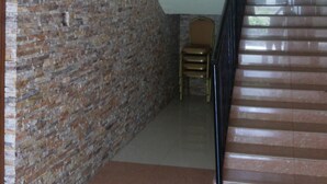A staircase with a brick wall on one side and a white ceiling on the other. - Rosevilla Hotel (Arua)