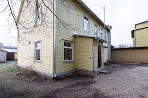 A two-story house with a front porch and a garage.